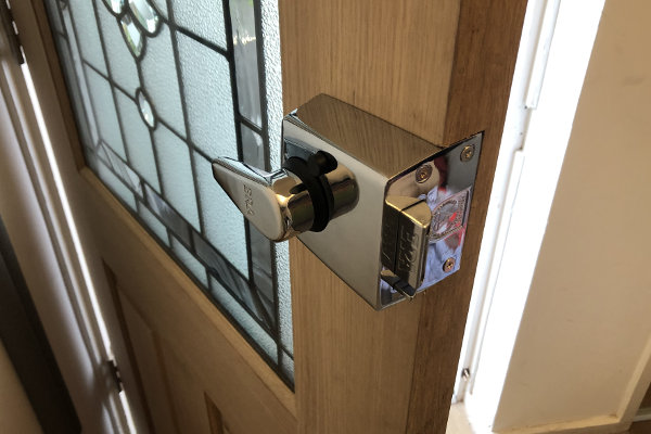 Shiny stainless steel ERA lock fitted onto door